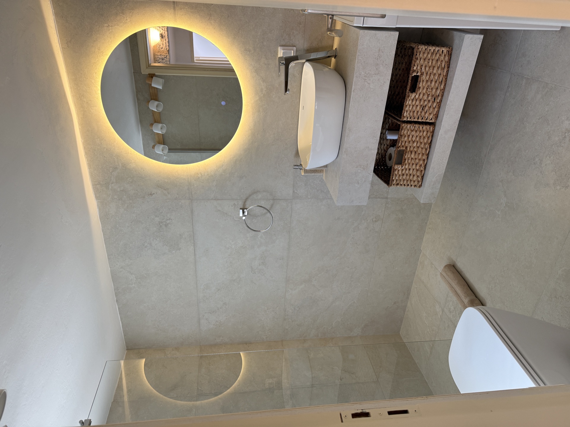 Bathroom with round backlit mirror and vessel sink, vacation rental Mani Greece