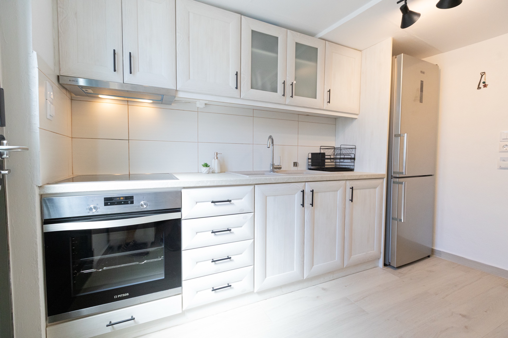 Modern fitted kitchen with oven and fridge, vacation rental Kotronas Greece