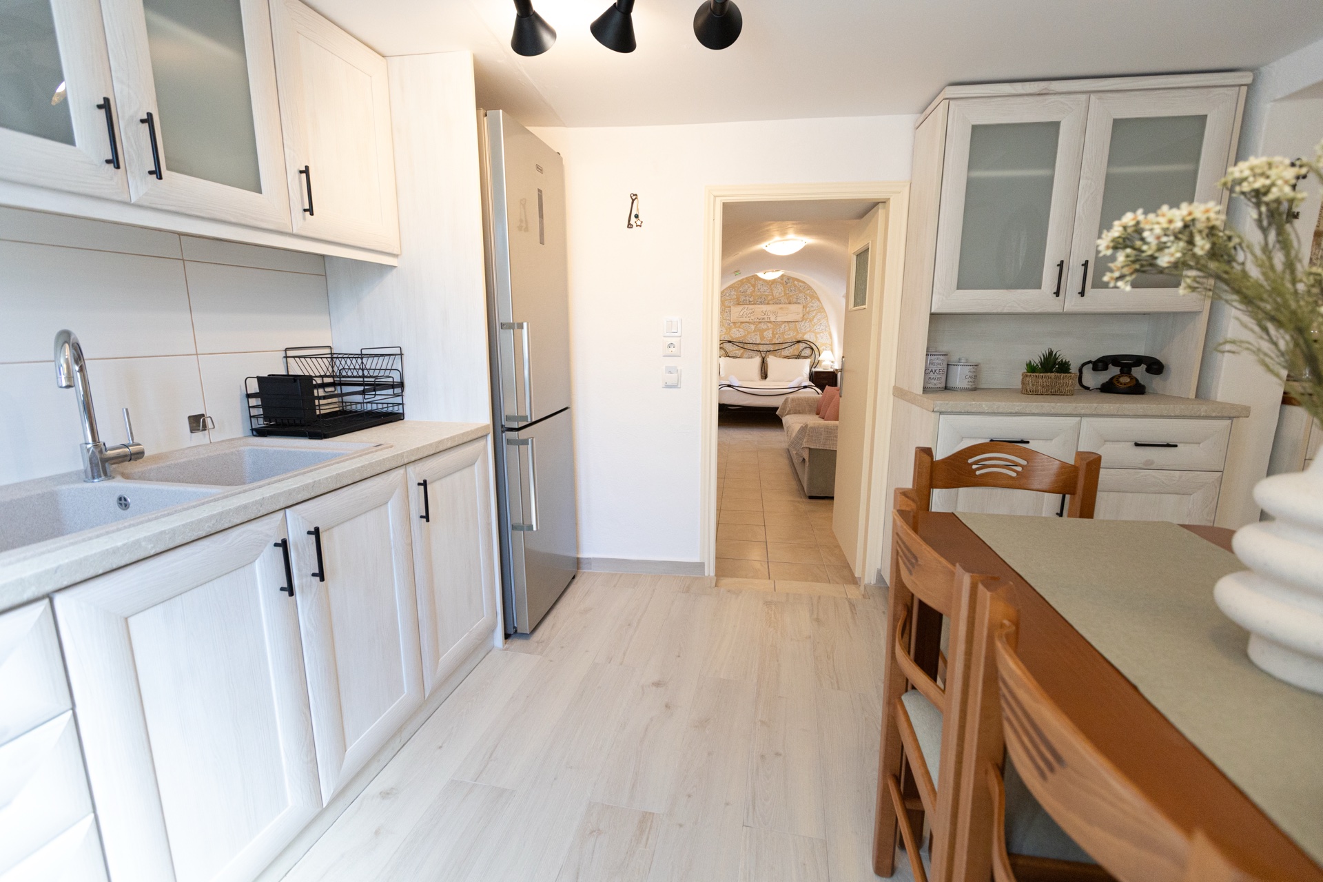 Kitchen perspective with dining table and bedroom view, Koufantonis Mansion Mani